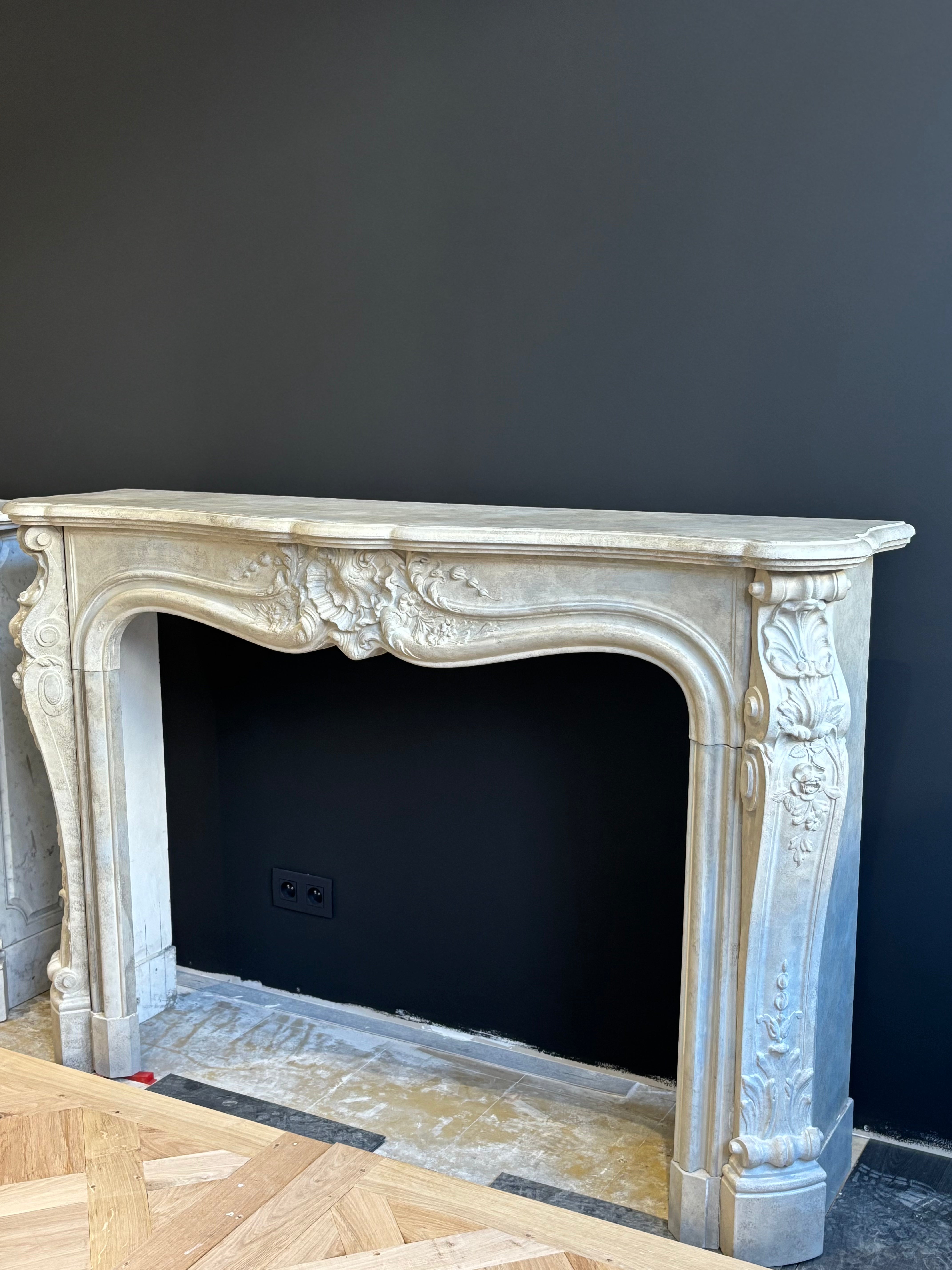 Classic Sculpted Stone Fireplace – Elegance and Refined Craftsmanship